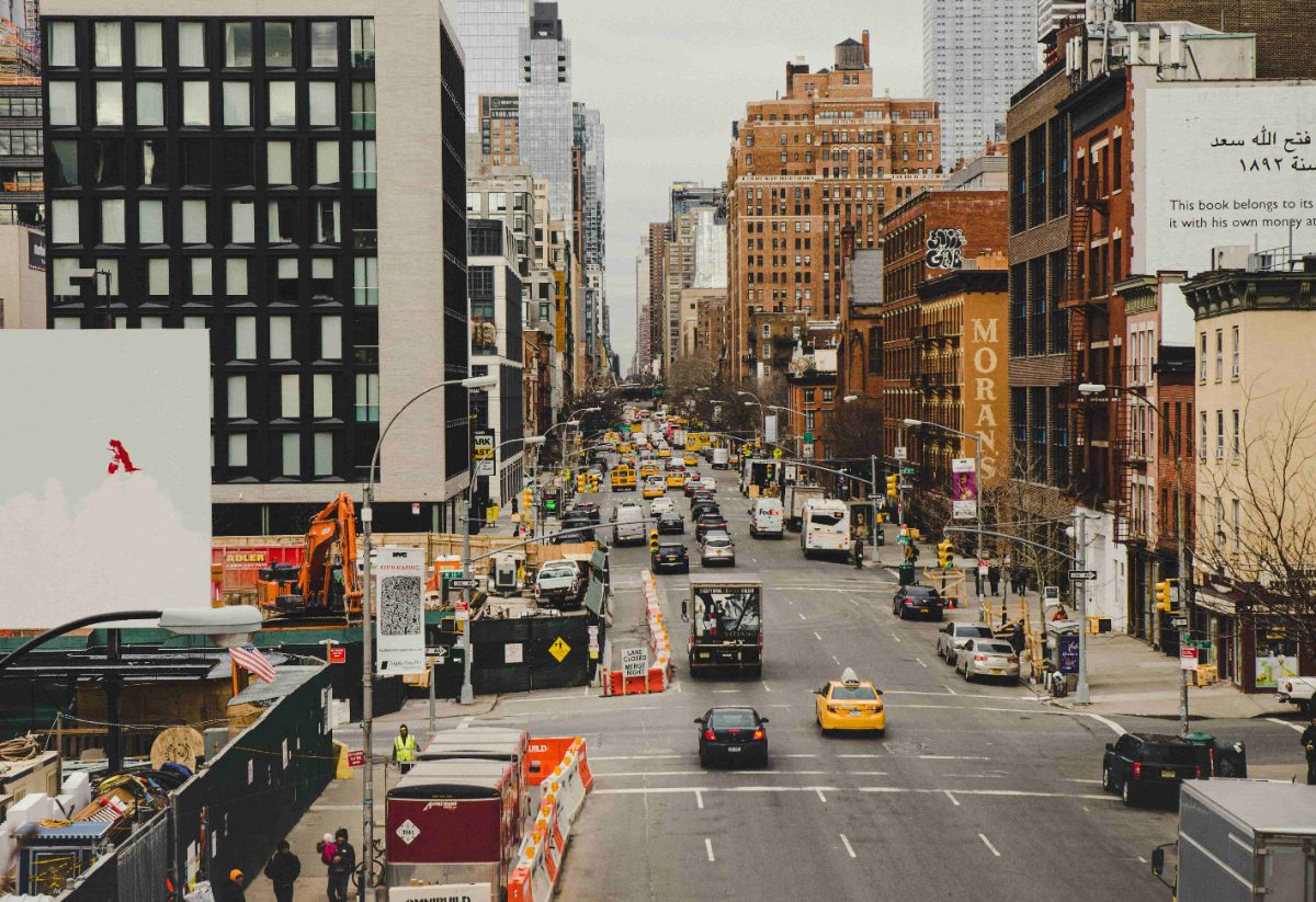 Busy city street lined with buildings and traffic