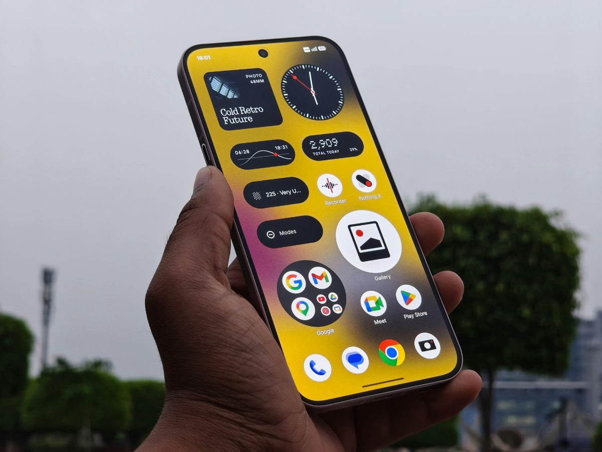Hand holding a smartphone with app widgets on the screen